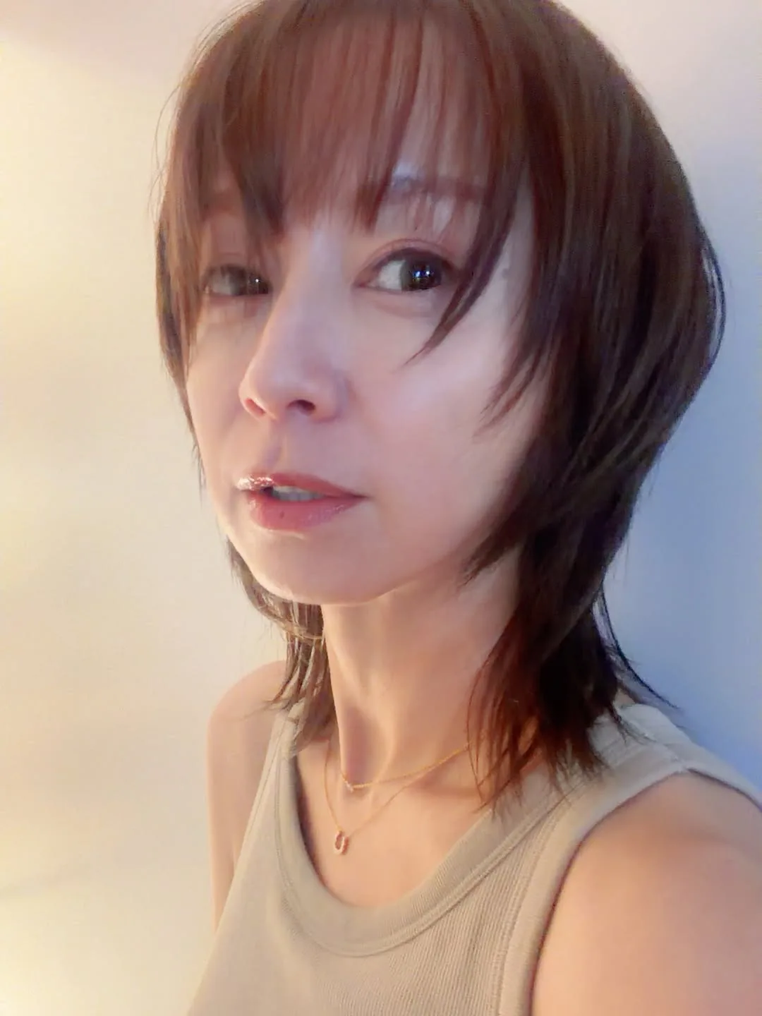 Wolf cut medium hair with blunt bangs and choppy layers