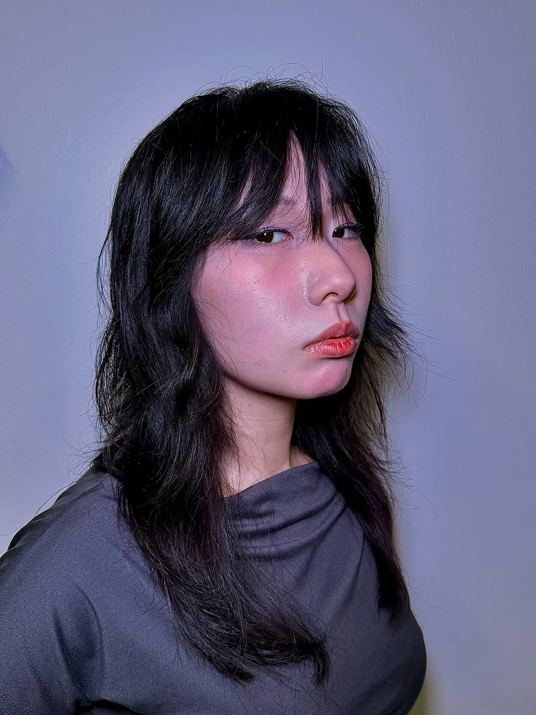 Korean wolf cut medium hair with wispy bangs and sleek layers