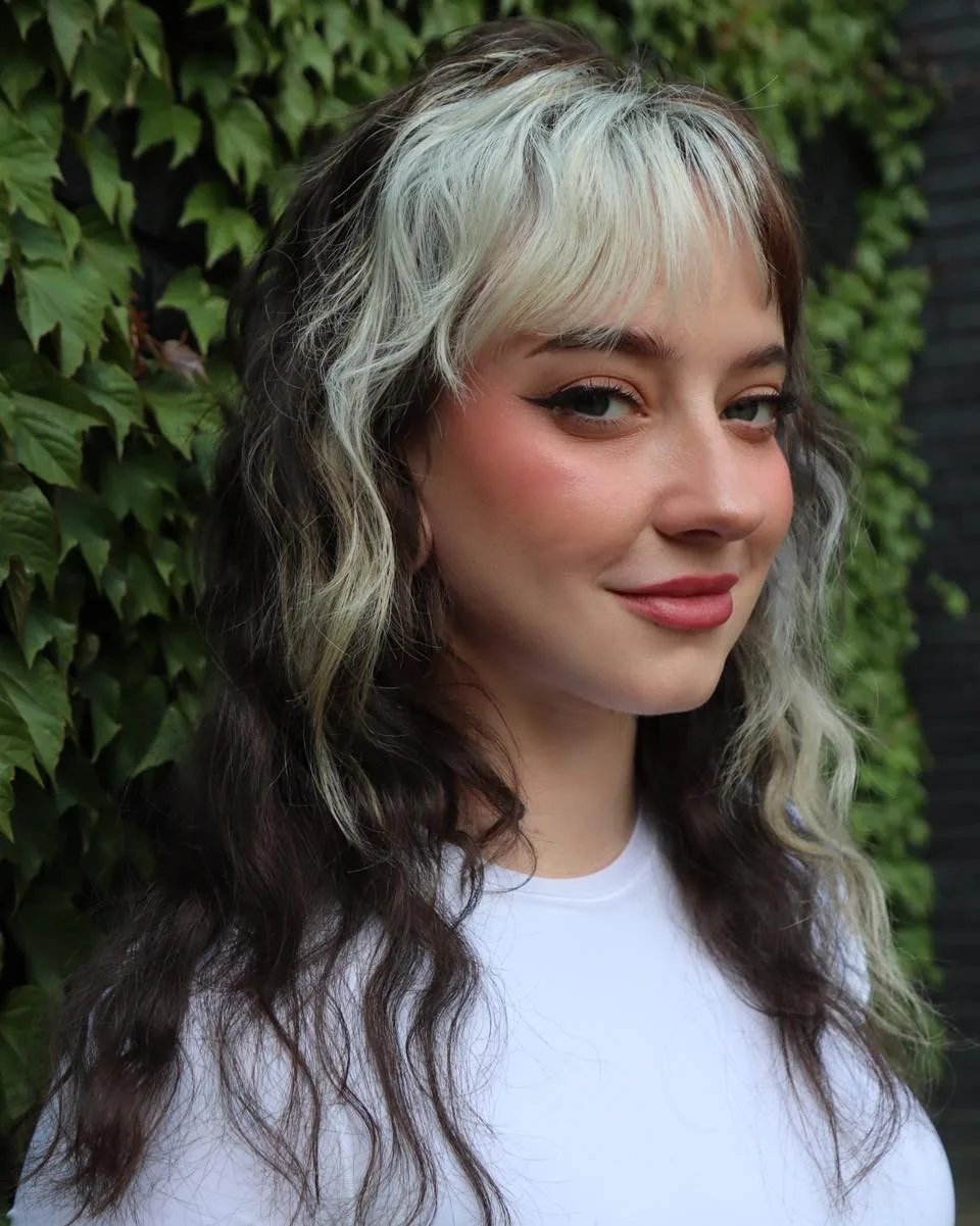 Wolf cut medium hair with silver money piece highlights and waves