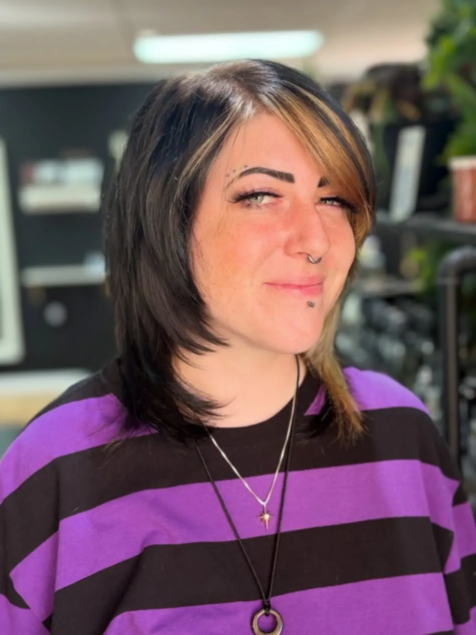 Two tone wolf cut medium hair with a blonde face framing streak